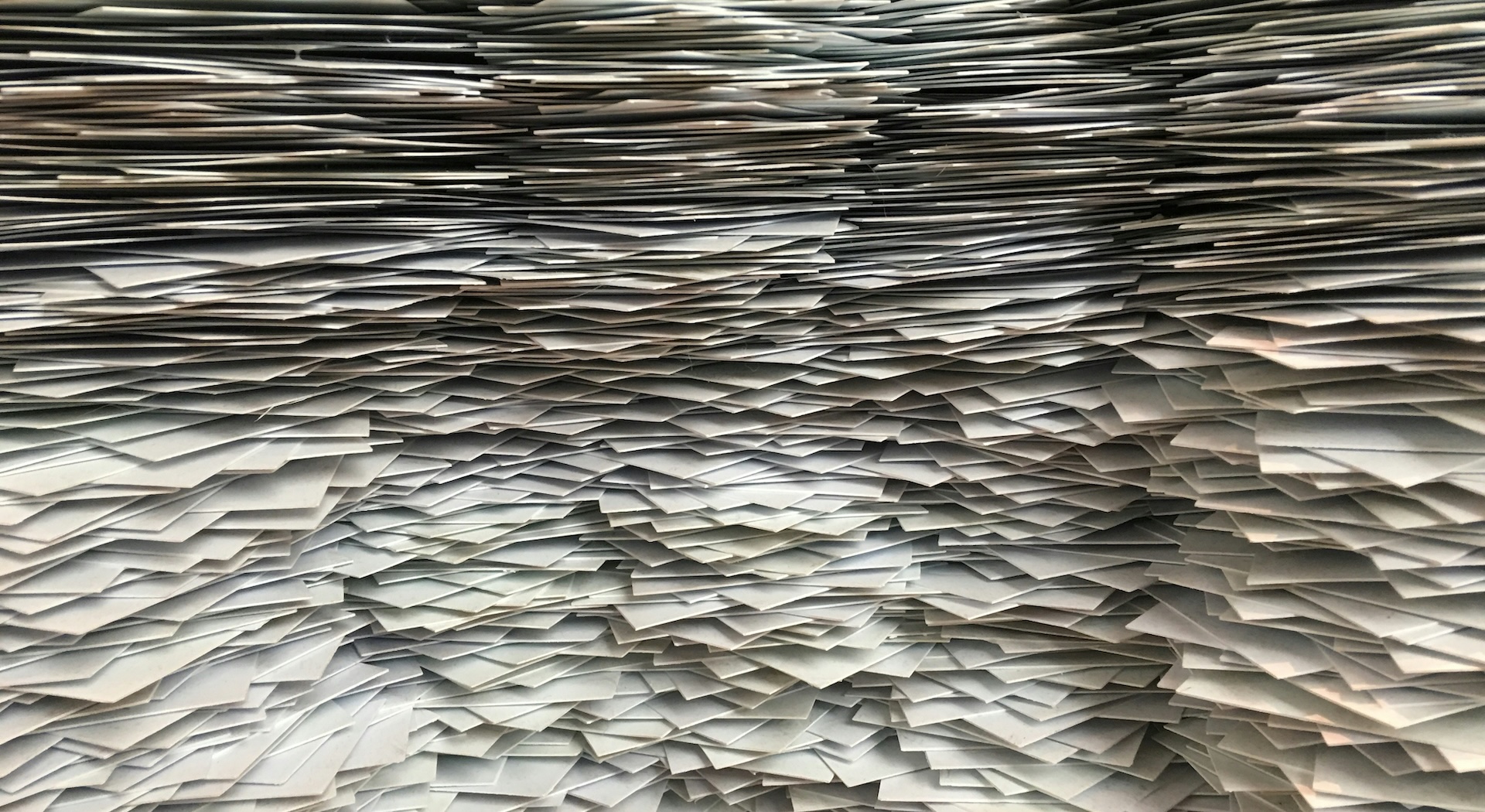 An enormous pile of papers, used to illustrate the value of distilling your ideas to one page